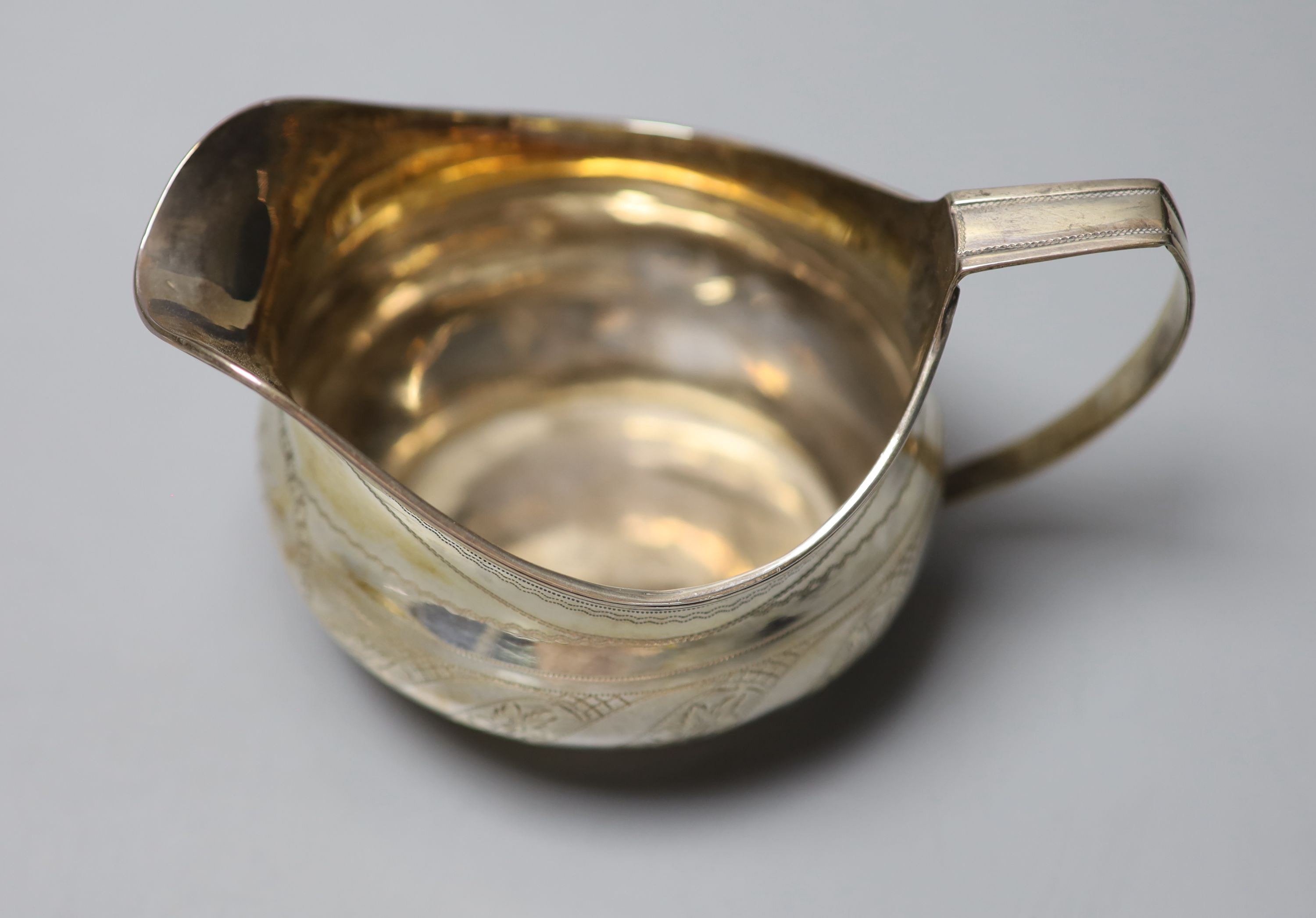 A George III silver cream jug, with engraved monogram, London, 1811, height 72mm, 92 grams.